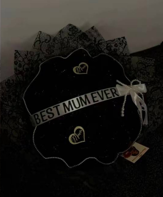 Black lace wrapped bouquet with a Best Mum Ever band