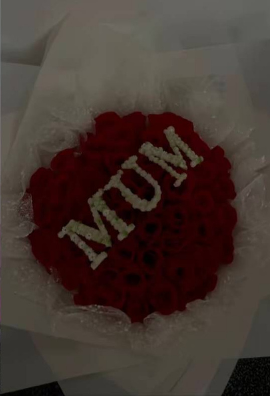 Red artificial Mother's Day bouquet spelling MUM