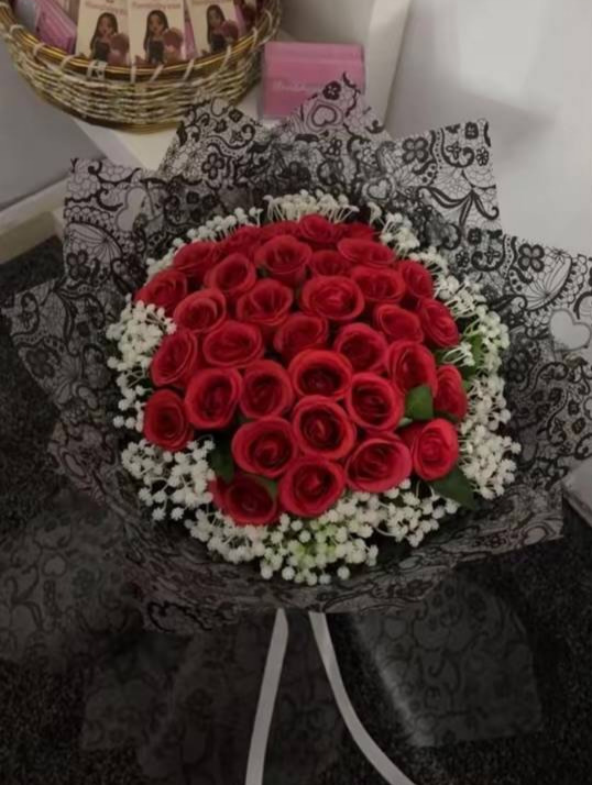 Red rose bouquet wrapped in black lace