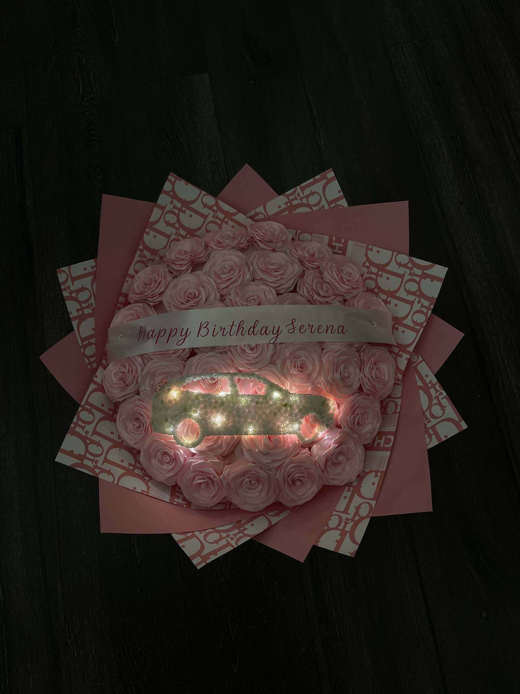 A close-up of a pink bouquet of flowers with a birthday congratulations.
