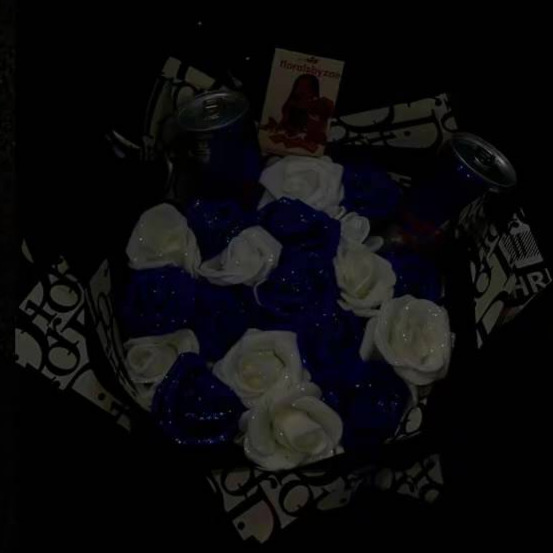 Close up of blue and white bouquet with Red Bull cans