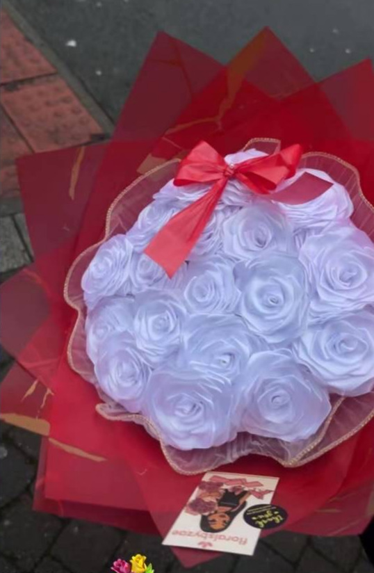 White rose bouquet with a red ribbon bow